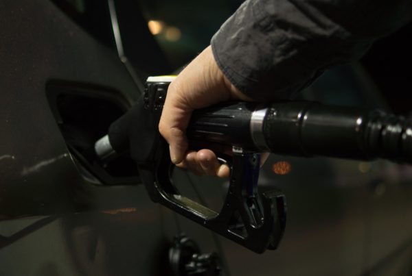 person filling up at gas station fuel