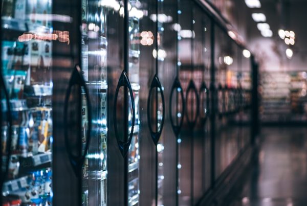 Aisle of refrigerators in a convenience store.