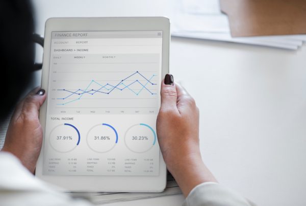 Woman using an iPad to view a finance report through inventory management software.