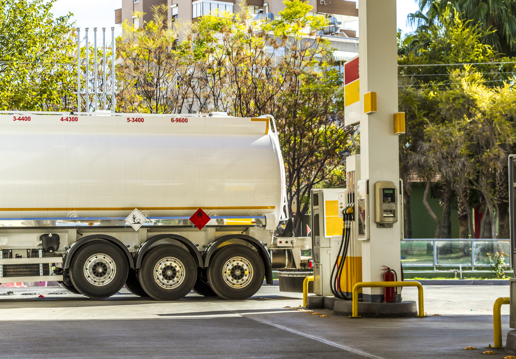 Fuel truck delivering gas at a gas station.