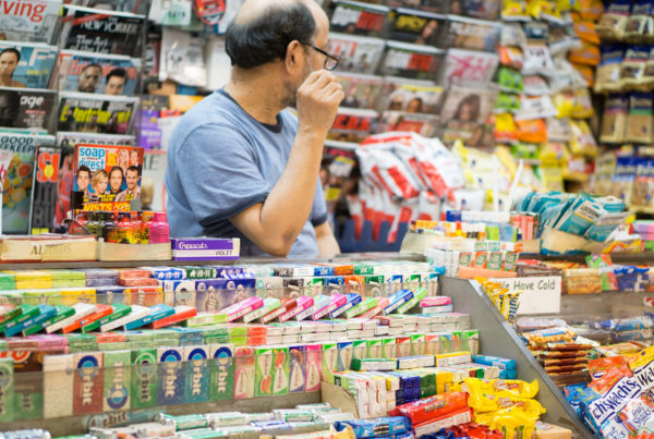 Convenience store manager looking over inventory.