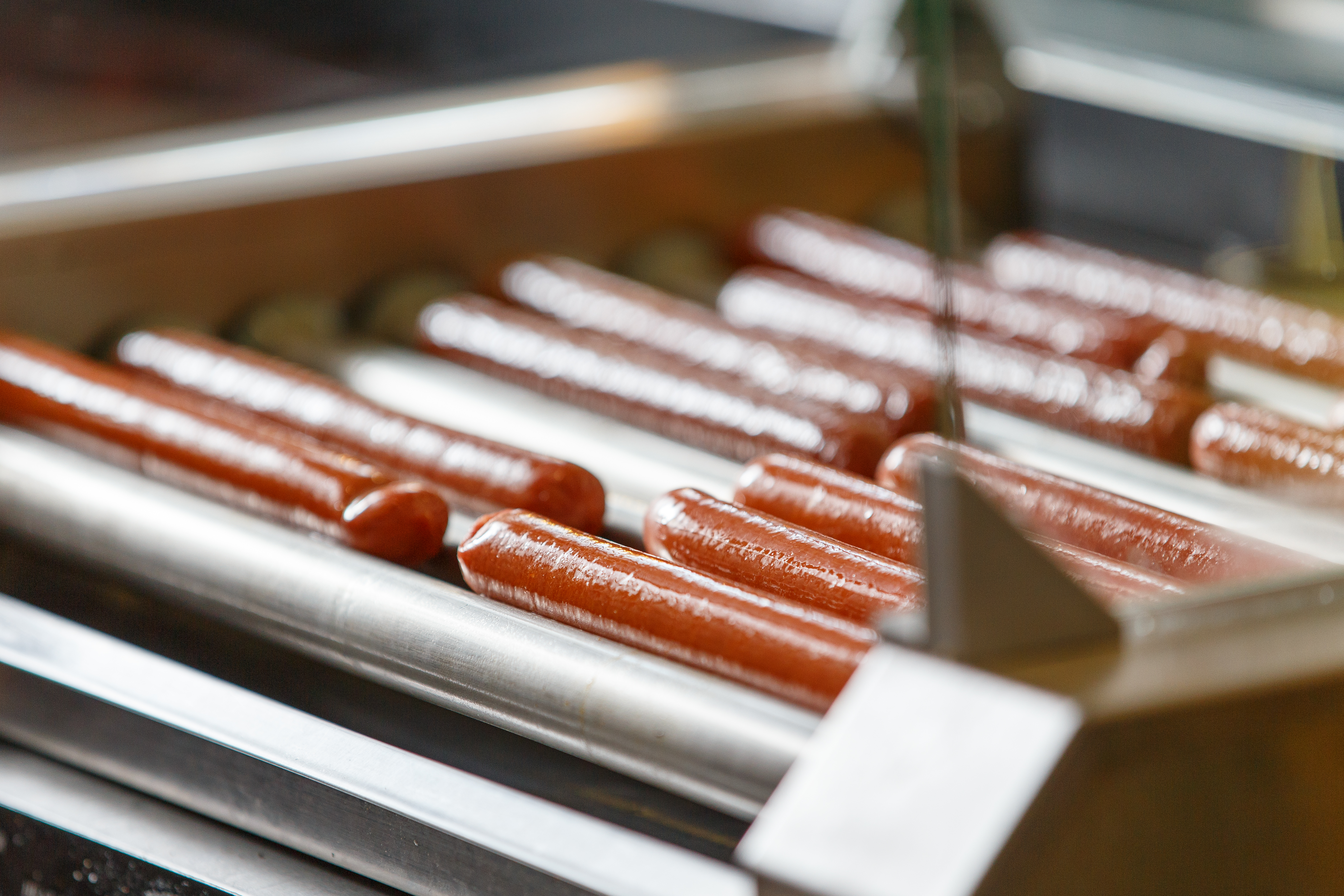 Hot dogs on a roller grill