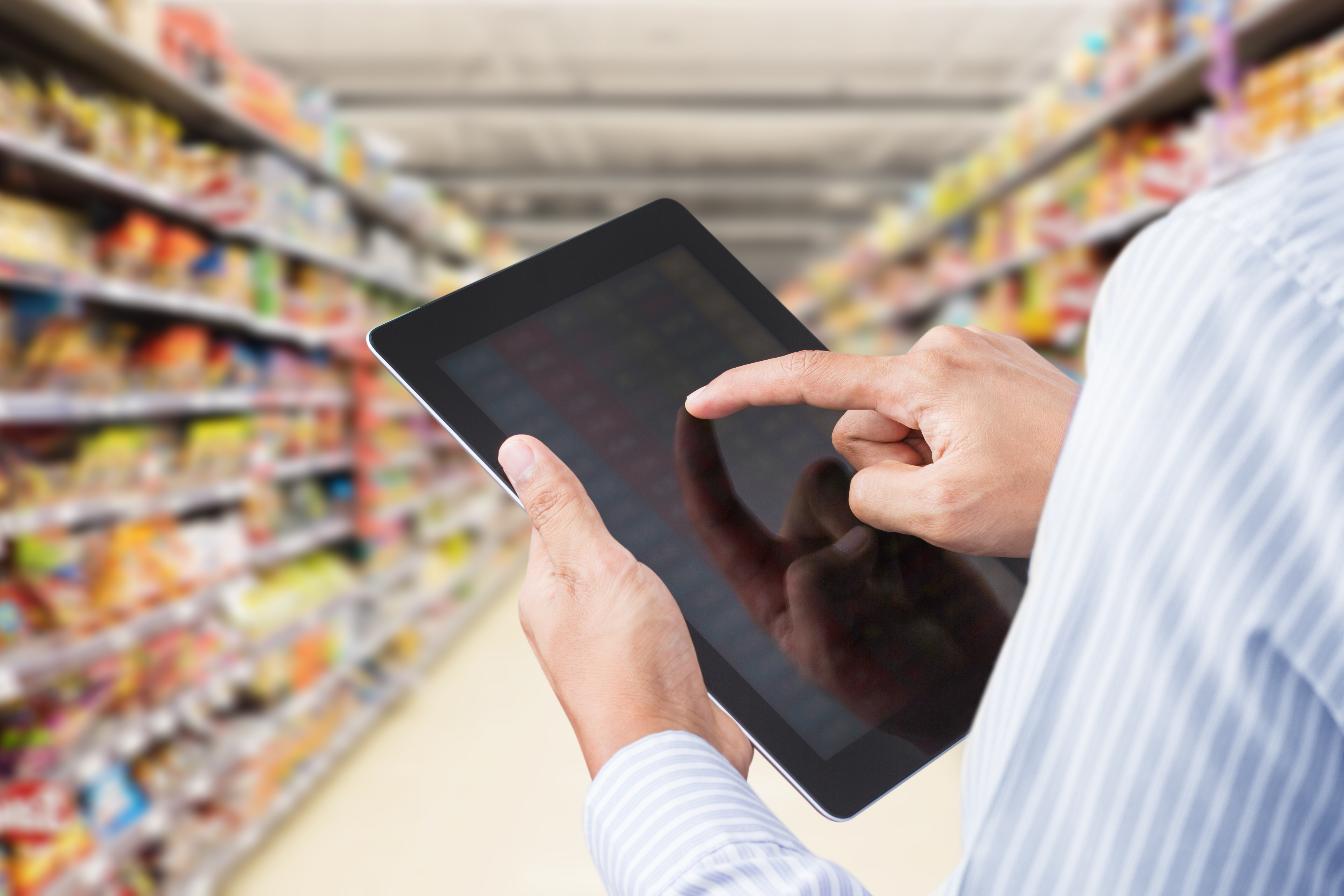 Man organizing inventory using electronic back office system.