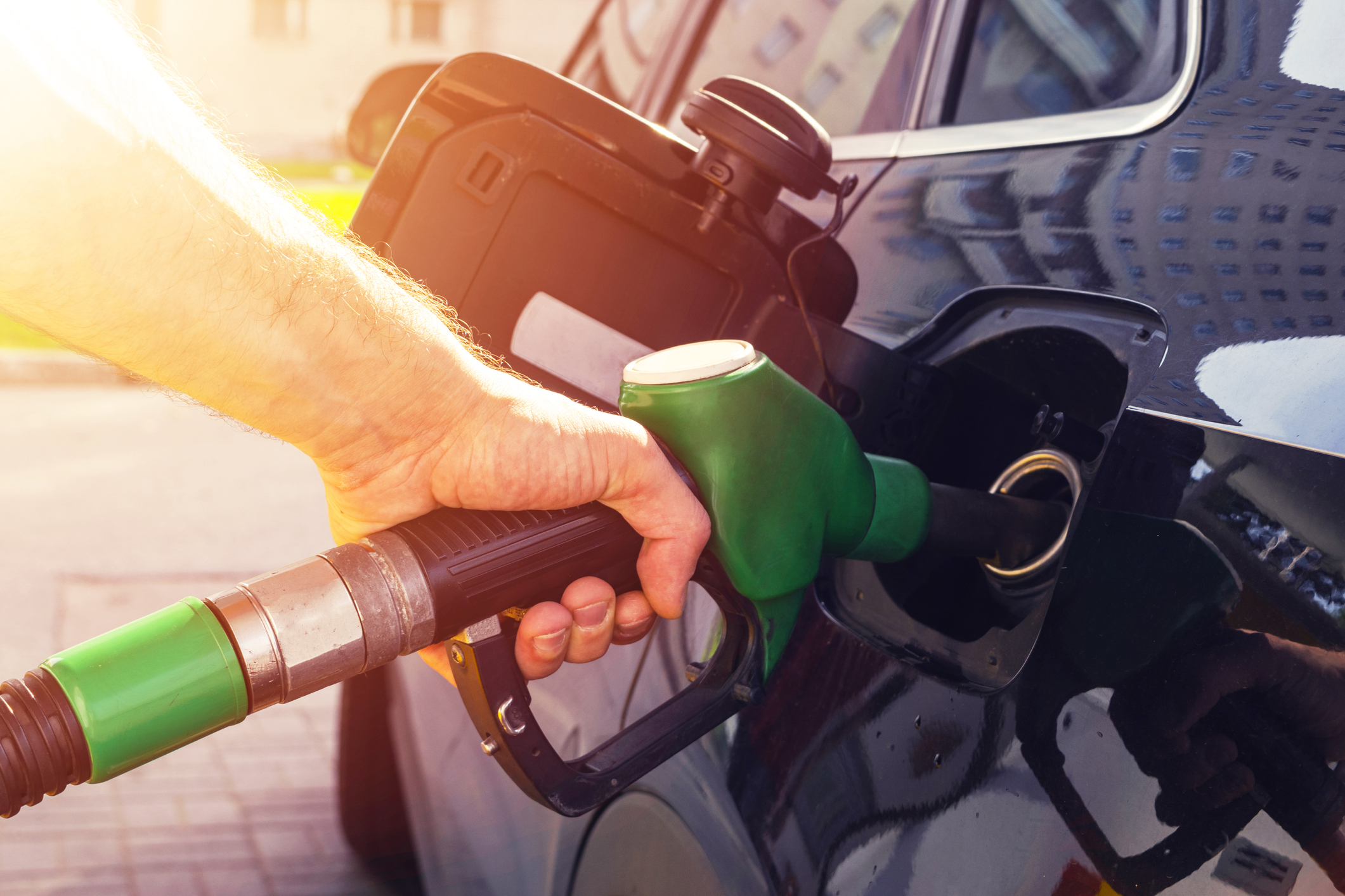 Refueling the car at a gas station fuel pump. Symbolizing automated fuel management